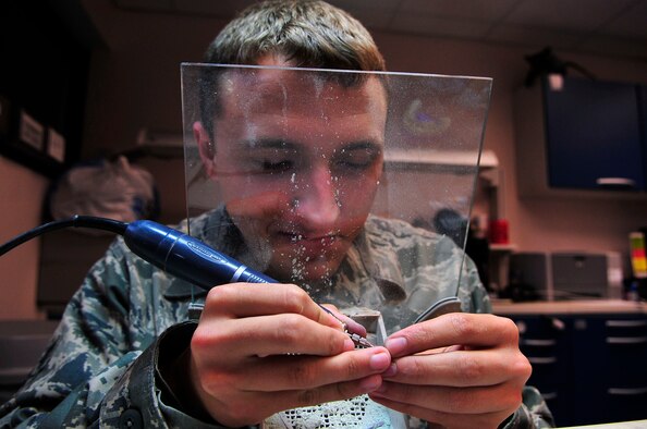 U.S. Air Force Senior Airman Justin Rhodes, 20th Dental Squadron dental lab technician, polishes a gold crown for a patient at Shaw Air Force Base, S.C., May 15, 2012. Rhodes is a native of Owensboro, Ky.(U.S. Air Force photo by Airman Nicole Sikorski/Released) 