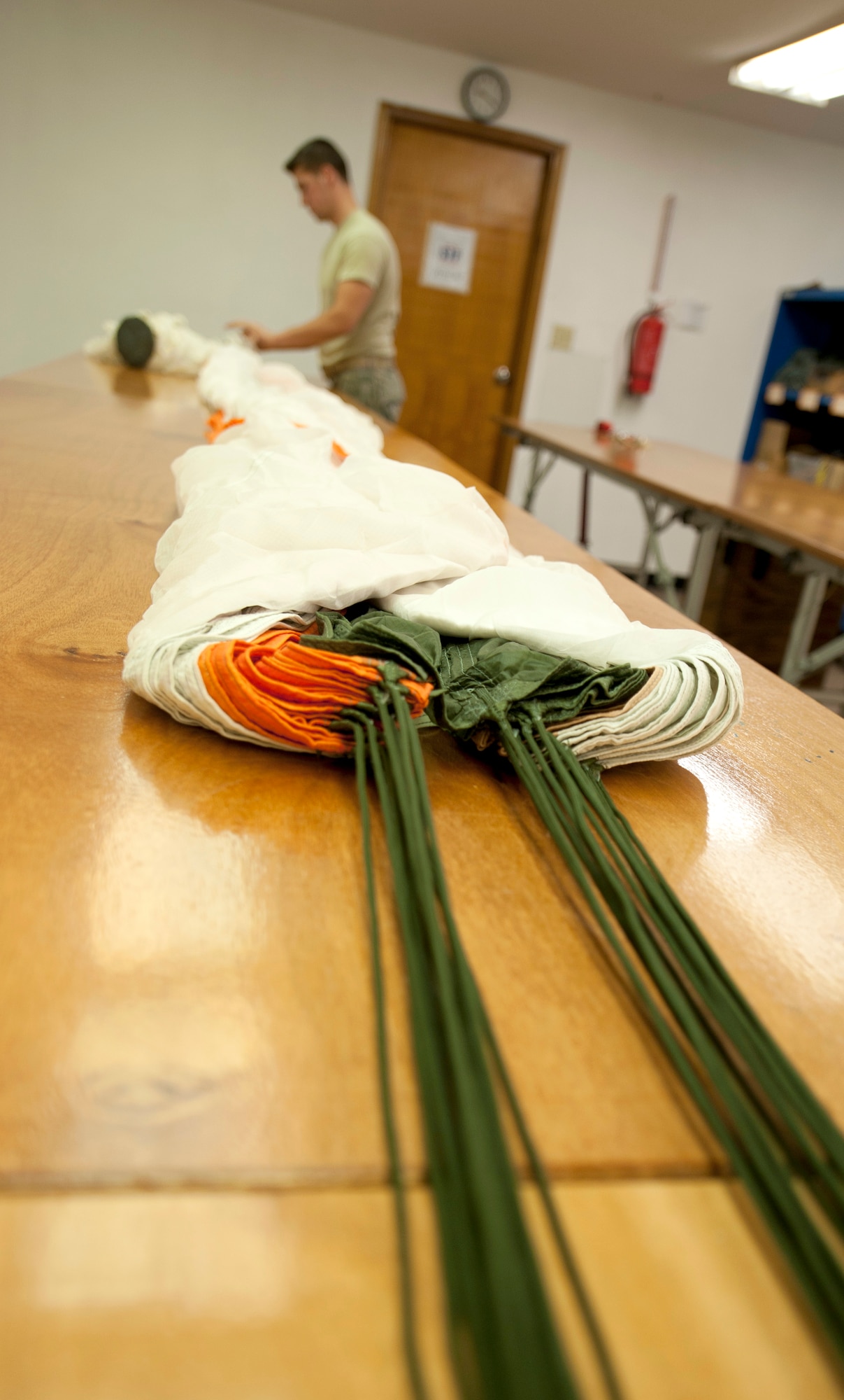 U.S. Airman 1st Class Michael Mauldin, 379th Expeditionary Operations Support Squadron aircrew flight equipment technician, prepares to repack the BA-22 parachute after conducting an inspection May 17, 2012. The inspection can take three hours per parachute. Mauldin is deployed from Dyess Air Force Base, Texas. (U.S. Air Force photo/Staff Sgt. Sheila deVera)