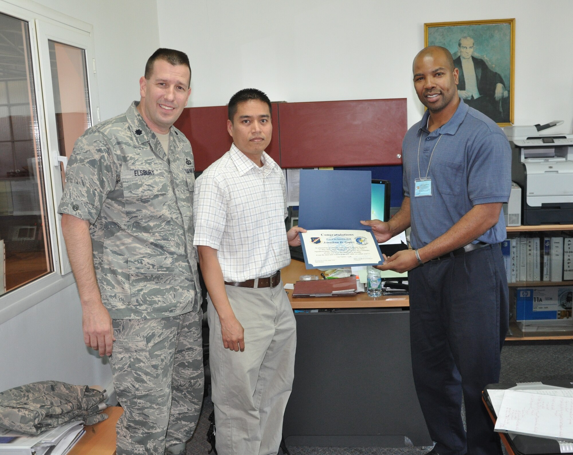 Tech. Sgt. Jonathan Gopez, 425th Air Base Squadron Logistics Readiness Flight,  receives the master sergeant selectee promotion certificate from Lt. Col. Joel Elsbury, left, 425th ABS commander, and Master Sgt. Roderick East, right, 425th ABS superintendent, for his selection for promotion to the rank of master sergeant May 17, 2012, at Izmir Air Base, Turkey. (U.S. Air Force photo by Master Sgt. Stanley Joslin/Released)