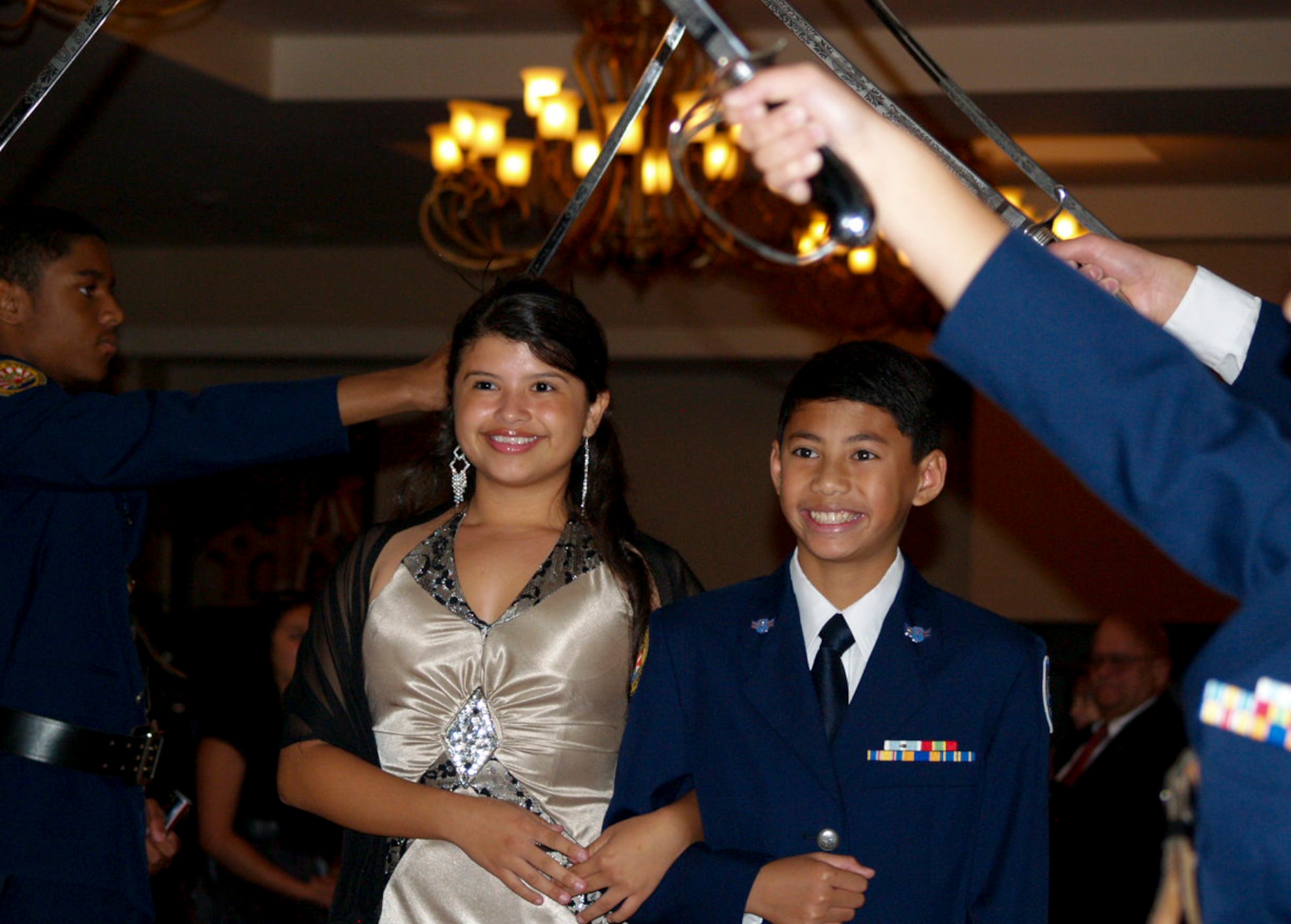 Air Force Junior Reserve Officer Training Corps Military Ball court members Lady Yoseiby Mejia and Lord Tassi Duenas walk through the procession to join the rest of the royal court members at the Kadena Officer’s Club on Kadena Air Base, Japan, May 12, 2012. Similar to a prom court, the Military Ball court members were nominated by their peers. (Air Force Junior ROTC courtesy photo)