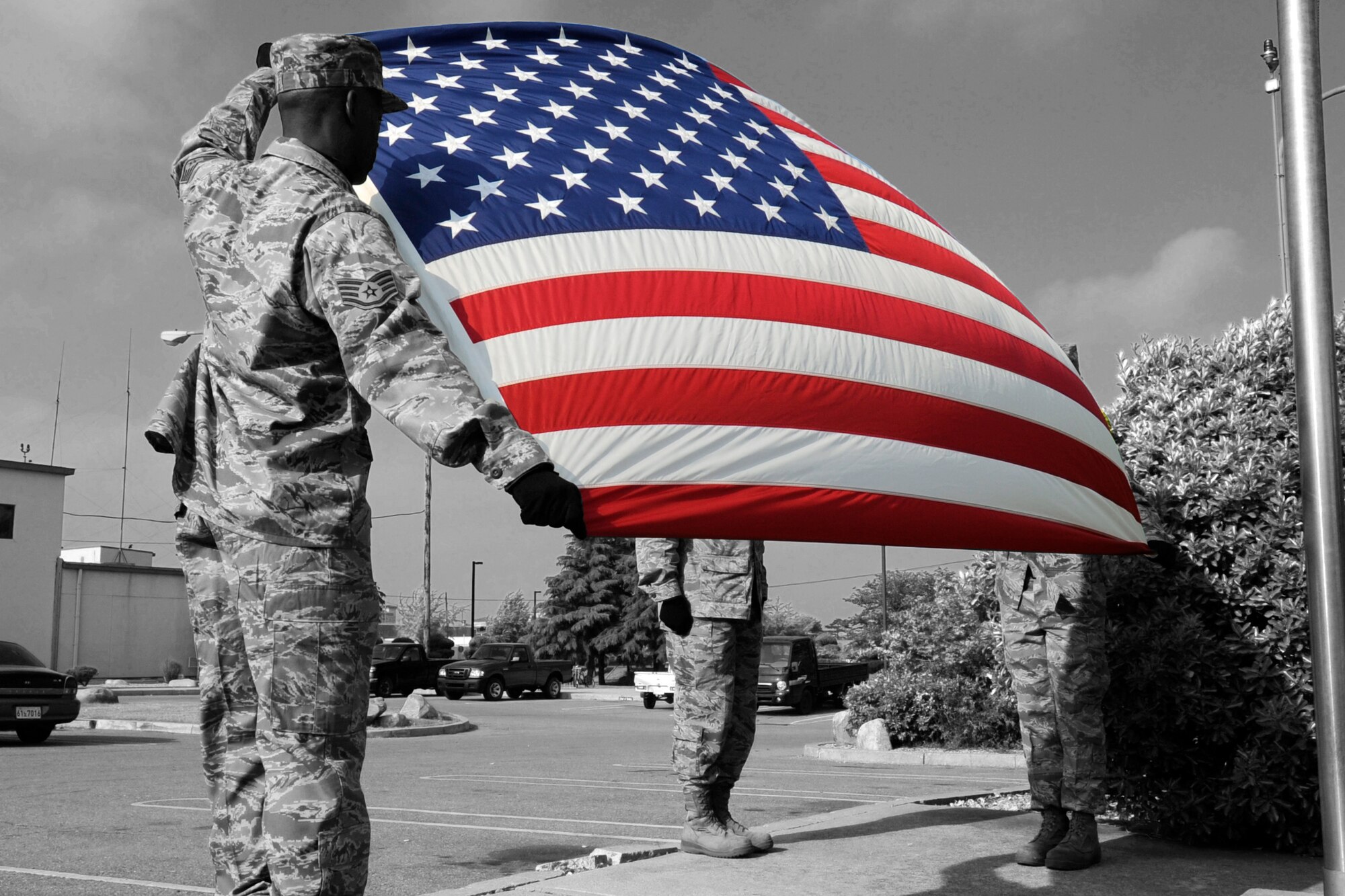 Members of the Kunsan Air Base Honor Guard prepare to fold the United States flag during a retreat ceremony May 18, 2012 on Kunsan Air Base, Republic of Korea. The retreat ceremony helped mark the end of Police Week, a national observance and memorial for fallen police officers. (U.S. Air Force illustration/ Senior Airman Jessica Hines)