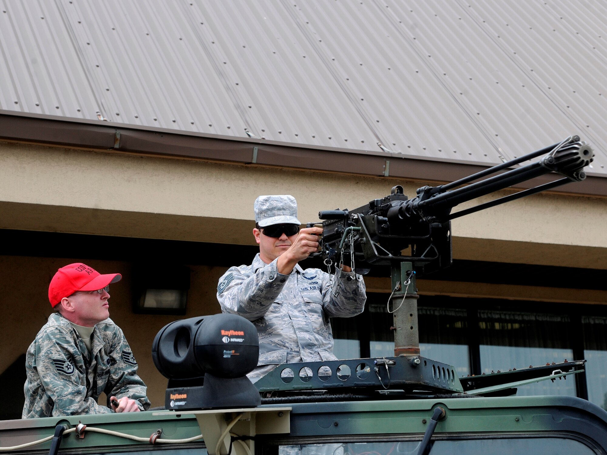 Staff Sgt. Ryan Silk, 8th Security Forces Squadron response force leader, shows Tech Sgt. Mathew Boyd, 8th Logistics Readiness Squadron, how to properly handle a .50-caliber machine gun during Police Week, May 16, 2012 on Kunsan Air Base, Republic of Korea. The demonstration was a part of Police Week, observed by members of the 8th SFS on Kunsan Air Base the week of May 15. (U.S. Air Force photo/Staff Sgt. Rasheen Douglas) 