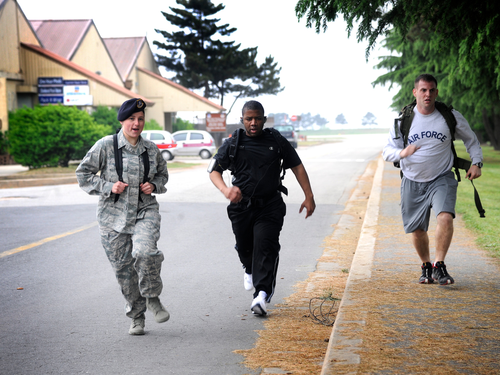 Senior Airman Tiffany Fyre, left, 8th Security Forces Squadron, runs alongside teammates during a relay challenge during Police Week, May 16, 2012 on Kunsan Air Base, Republic of Korea. The Defender Challenge consisted of a two-mile ruck march, ammo carry, low crawl, fireman’s carry, and pushing a Humvee.  (U.S. Air Force photo/Staff Sgt. Rasheen Douglas) 