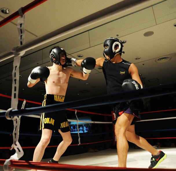 Norihiro Sugawara, Japanese national, left, gets hit with a right hook by Kazunari Kimura, Japanese national, during the Friday fight night event at Misawa Air Base, Japan, May 18, 2012. The match was won by Norihiro Sugawara with a unanimous vote from the judges. The event allowed amateur fighters showcase their boxing skills to family, friends and co-workers. (U.S. Air Force photo by Airman Kenna Jackson/Released)