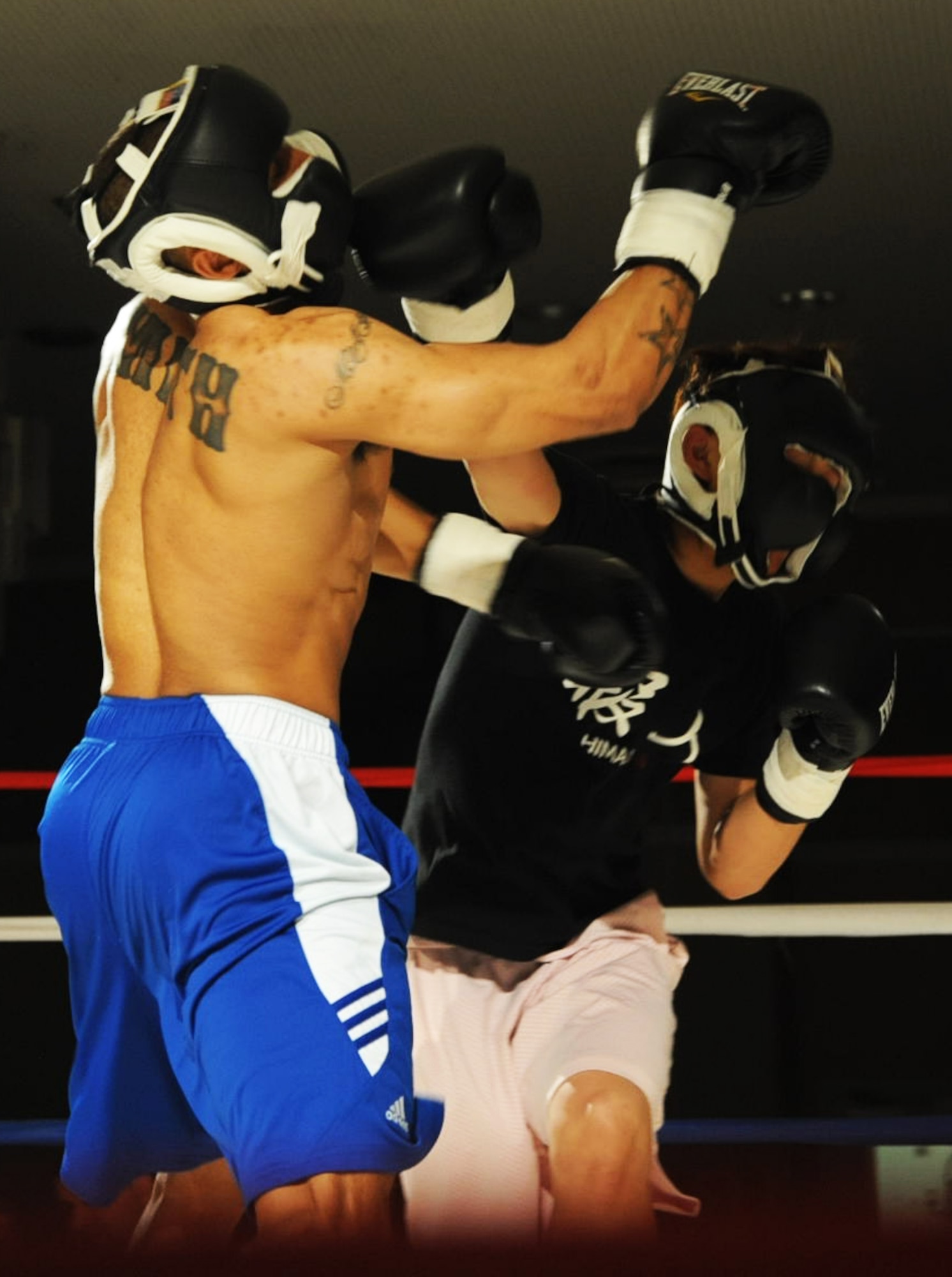 Yuya Takahashi, Japanese national, right, slams his fist into Senior Airman Marques Smith’s, 35th Communication Squadron information proctection technician, face during a welterweight boxing match at Misawa Air Base, Japan, May 18, 2012. Smith won the match with a unanimous vote from the judges. The next fight night is scheduled for Aug. 10, 2012. (U.S. Air Force photo by Airman Kenna Jackson/Released)