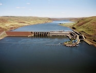 The dam is 2,655 feet long with an effective height of about 100 feet. It is located on the Snake River near Starbuck, Wash., and upstream of Lake West, the reservoir formed by Lower Monumental Dam. It is a concrete gravity dam with an earthfill abutment embankment. It includes a navigation lock and eight-bay spillway 512 feet long, which has eight 50 feet by 60 feet tainter gates.