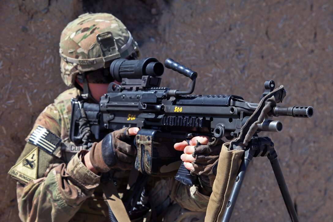 U.S. Army Sgt. Cliff Collins scans the area using the scope on his M249 squad automatic weapon at the Khoshi District Center in Afghanistan’s Logar province, May 12, 2012. Collins is assigned to the 201st Georgia Agribusiness Development Team 2.
