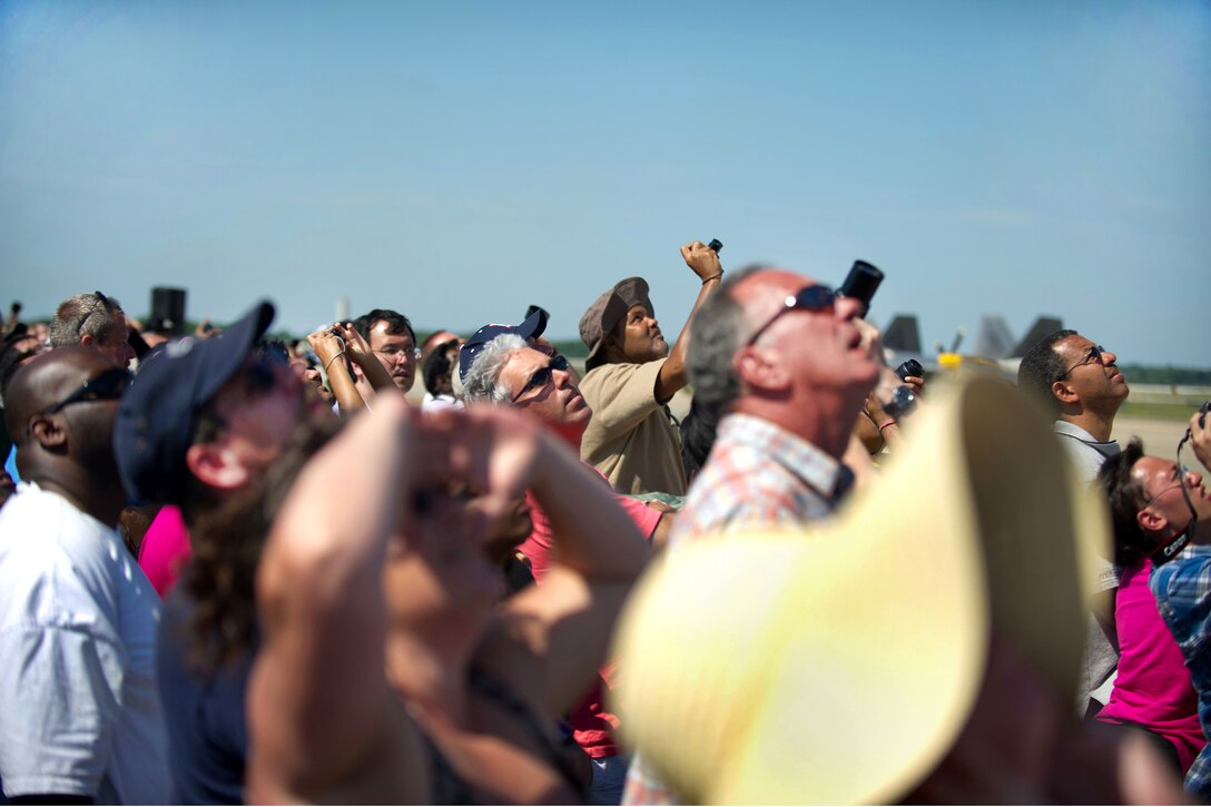 Members of the crowd photograph the Blue Angels, the U.S. Navy's flight demonstration squadron, during its performance at the 2012 Joint Service Open House and Air Show on Joint Base Andrews, Md., May 19, 2012.