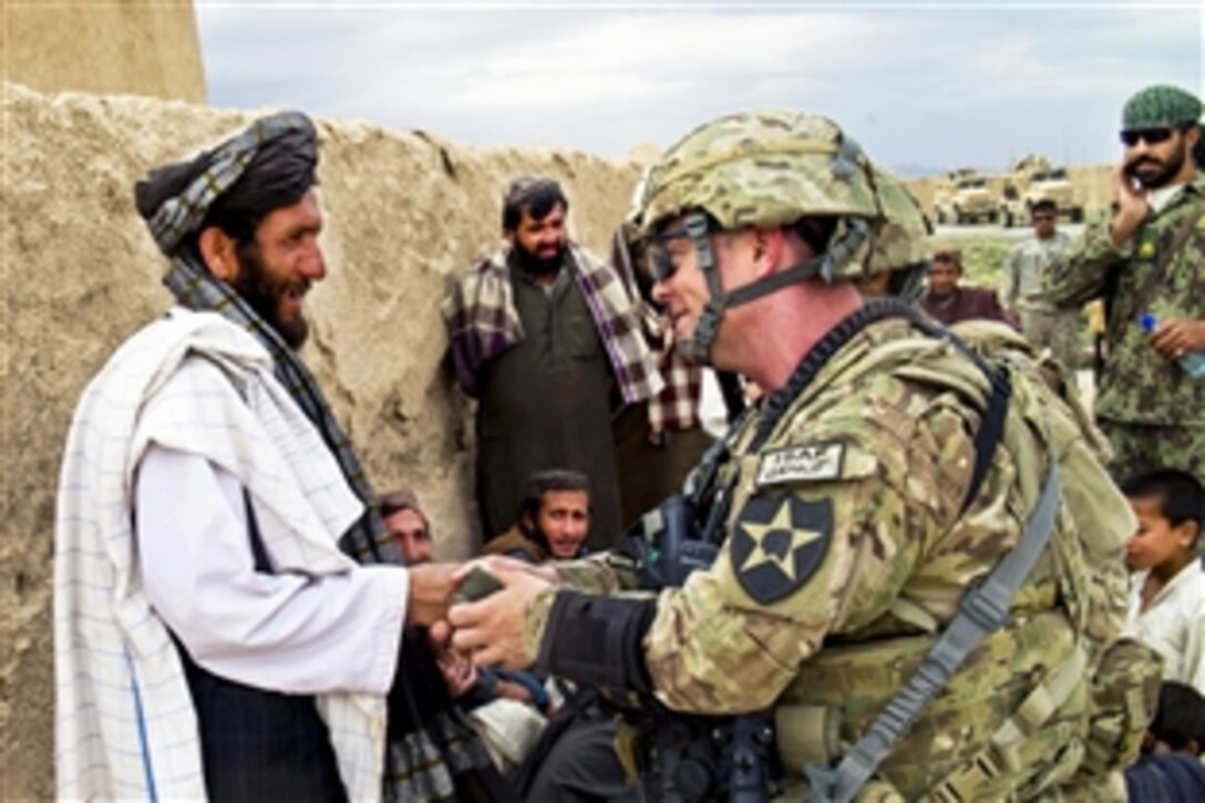 U.S. Air Force Lt. Col. Marc Sheie, right, greets a village elder in northern Qalat, Afghanistan, May 16, 2012. Sheie, who commands Provincial Reconstruction Team Zabul, discussed future projects with the village elder.