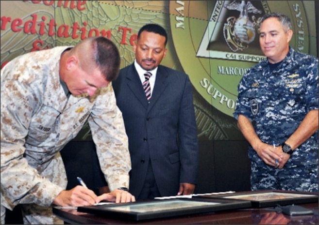 Colonel Christopher Snyder, Marine Corps Tactical Systems Support Activity’s Commanding Officer (left), and Captain Bryan Lopez, Executive Officer for the U.S. Navy Space and Naval Warfare Systems Command (right) formally sign Memorandum of Understandings that partnered their service’s various test facilities and capabilities with the U.S. Army’s Central Technical Support Facility, thus becoming the latest members to join the Federation of Net-Centric Sites (FaNS). Officiating the FaNS certification event held at Camp Pendleton on May 22nd was Mr. Steven Roscoe, Director of System-of-System Integration and Interoperability, Office of the Army Chief Information Officer. The FaNS network is designed to allow the Army to grow its real-time integration and interoperability testing capabilities by leveraging existing testing facilities inside and outside the Army.