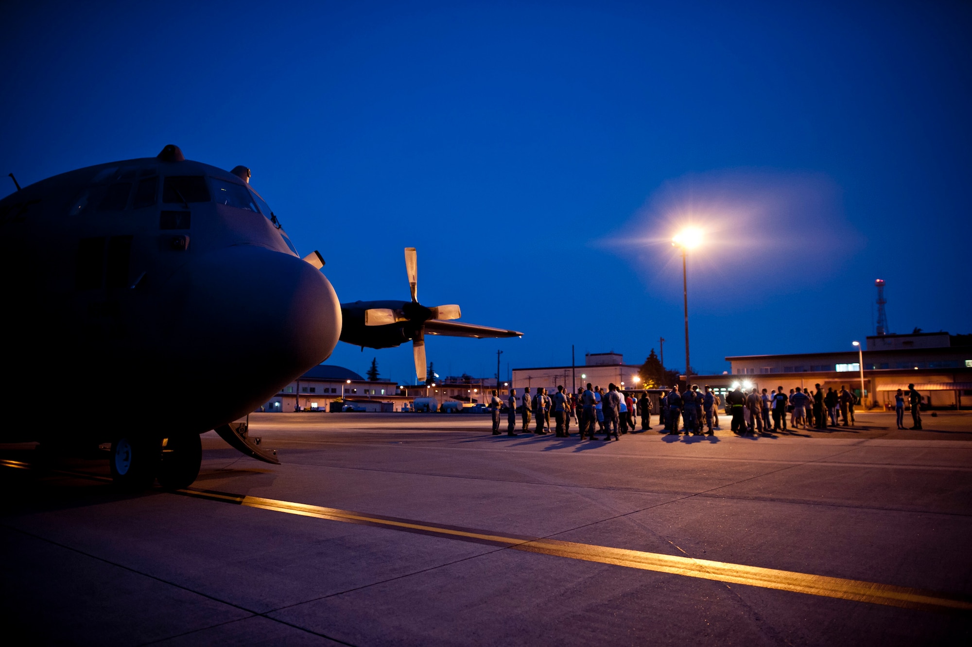YOKOTA AIR BASE, Japan -- An assembled crowd welcomes returning Airmen from the 36th Airlift Squadron and the 374th Aircraft Maintenance Squadron at Yokota Air Base, May 19, 2012. The Airmen had been deployed to Southwest Asia for four months. (U.S. Air Force photo by Staff Sgt. Samuel Morse)