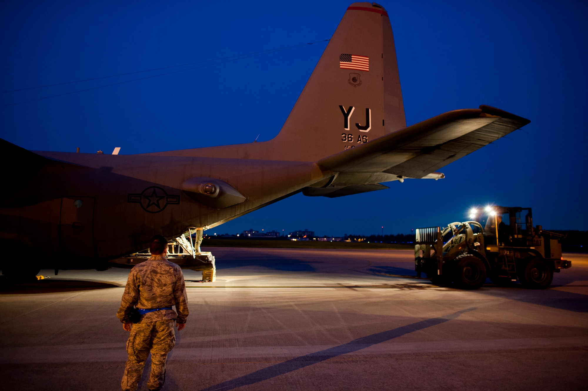YOKOTA AIR BASE, Japan -- Airmen unload a C-130 Hercules at Yokota Air Base, May 19, 2012. The aircraft and its passengers had just returned from a four-month deployment to Southwest Asia. (U.S. Air Force photo by Staff Sgt. Samuel Morse)