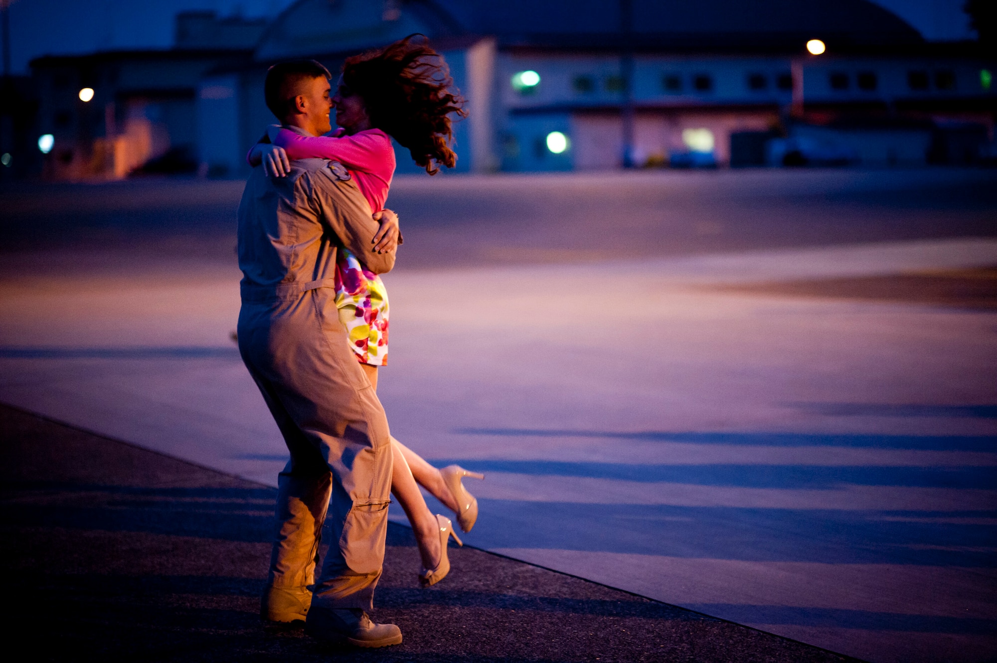 YOKOTA AIR BASE, Japan -- 1st Lt. Richard Culver, left, 36th Airlift Squadron navigator, hugs his wife, Kallie, at Yokota Air Base, Japan, May 19, 2012. This was their first reunion in four months following his return from deployment to Southwest Asia. (U.S. Air Force photo by Staff Sgt. Samuel Morse)