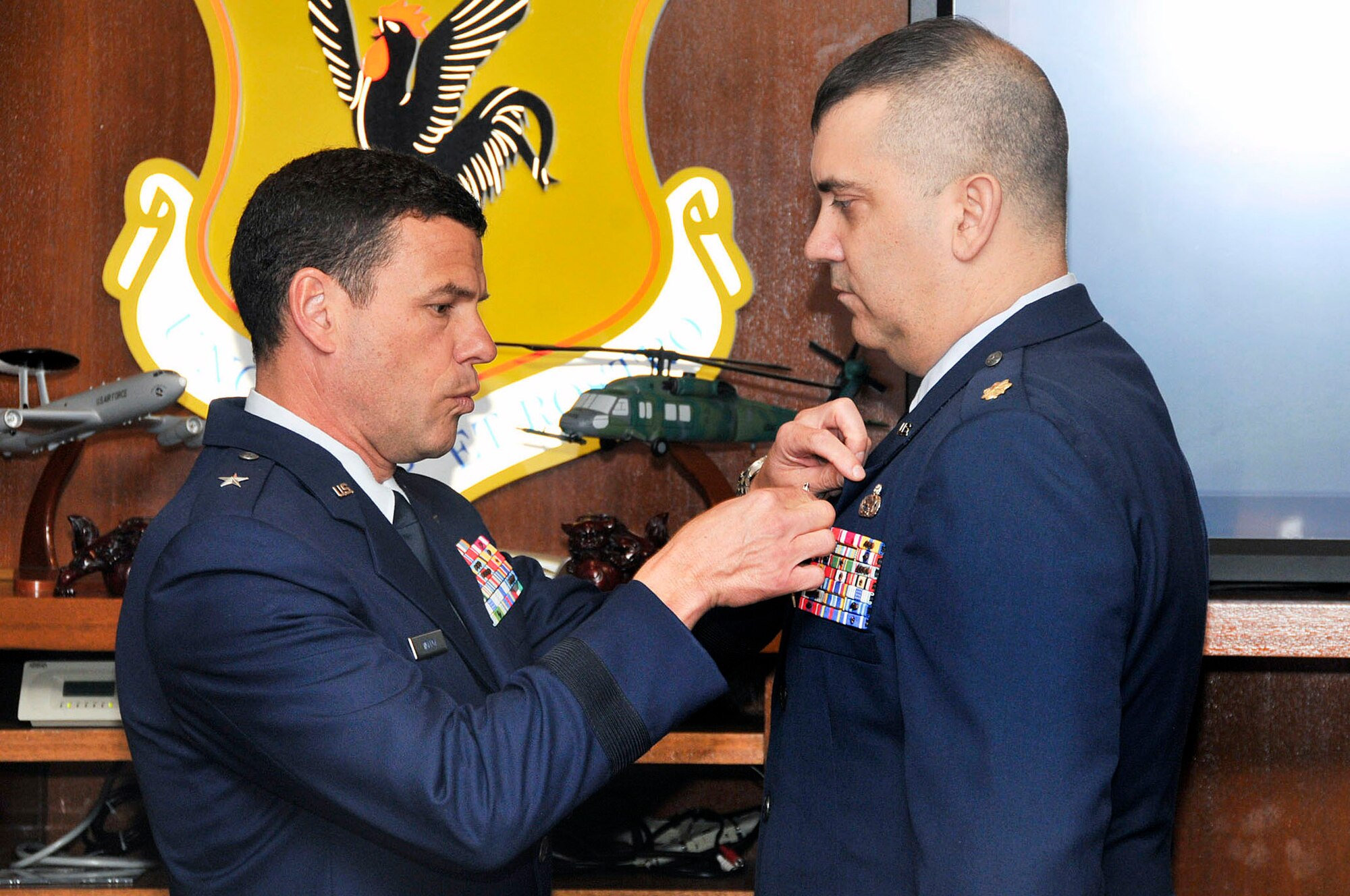U.S. Air Force Brig. Gen. Matt Molloy, 18th Wing commander, pins a Bronze Star Medal on U.S. Air Force Maj. Jeffrey Hunziker, 718th Aircraft Maintenance Squadron, during the Kadena Team staff meeting on Kadena Air Base, Japan, May 21, 2012. Hunziker received the Bronze Star for his meritorious service as commander of the 442nd Air Expeditionary Advisory Squadron at Kandahar Air Field, Afghanistan. (U.S. Air Force photo/Staff Sgt. Darnell T. Cannady)