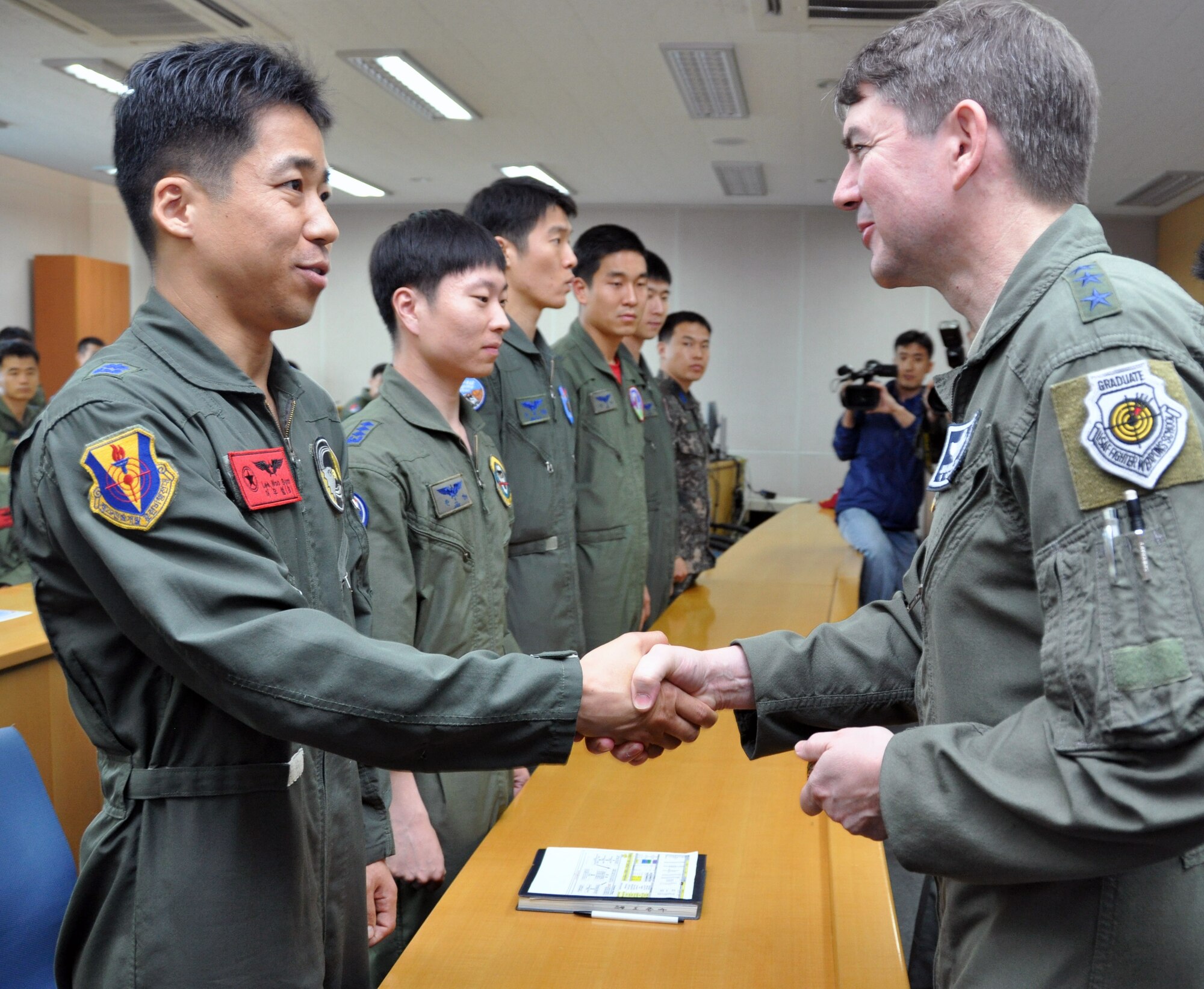 Lt. Gen. Jan-Marc Jouas, 7th Air Force commander, greets Republic of Korea airmen participating in joint exercise Max Thunder at Gwangju Air Base, Republic of Korea, May 15, 2012. Throughout the exercise, Airmen proved their ability to generate day and night flight sorties, conduct joint combat search and rescue operations, accept follow-on forces, conduct wartime operations, and successfully complete combat air drops. (U.S Air Force photo/Airman 1st Class Michael Battles)