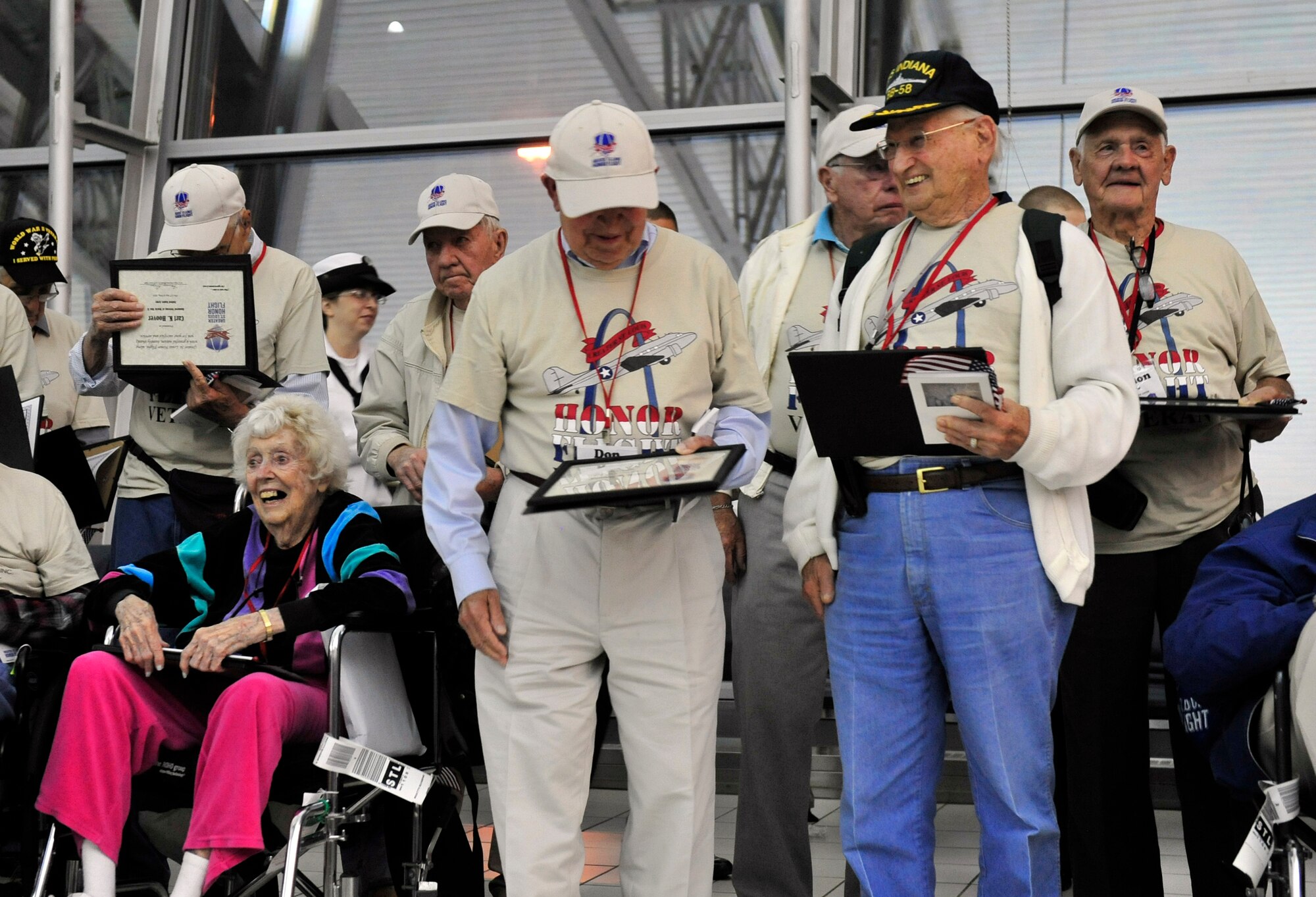 World War II veterans are presented a group photograph and letter of appreciation by active duty members assigned to Scott Air Force Base Ill., after their trip to the memorials in Washington D.C. May 21 sponsored by the Greater St Louis Honor Flight program.  Their family members and friends were waiting watching and cheering for them in the audience.  (U.S. Air Force photograph/ Staff Sgt. Stephenie Wade)