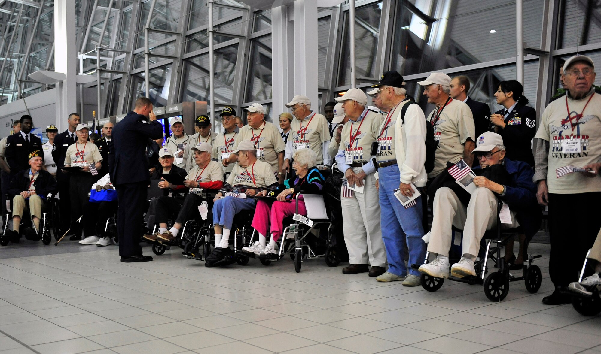 World War II veterans are presented a group photograph and letter of appreciation by active duty members assigned to Scott Air Force Base Ill., after their trip to the memorials in Washington D.C. May 21 sponsored by the Greater St Louis Honor Flight program.  Their family members and friends were waiting watching and cheering for them in the audience.  (U.S. Air Force photograph/ Staff Sgt. Stephenie Wade)