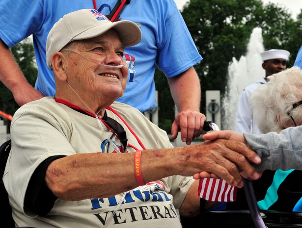 Middle School Students greet World War II veterans by shaking their hands and presenting them a small American flag outside the WWII memorial in Washington D.C. The trip is part of a program called the Greater St. Louis Honor Flight, a non-profit that takes World War II veteran to the to the memorials.  The WWII memorial honors the 16 million who served in the armed forces of the U.S. during World War II, the more than 400,000 who died, and the millions who supported the war effort from home. Symbolic of the defining event of the 20th Century, the memorial is a monument to the spirit, sacrifice, and commitment of the American people to the common defense of the nation and to the broader causes of peace and freedom from tyranny throughout the world. The memorial opened to the public on April 29, 2004 (U.S. Air Force photograph/ Staff Sgt. Stephenie Wade)