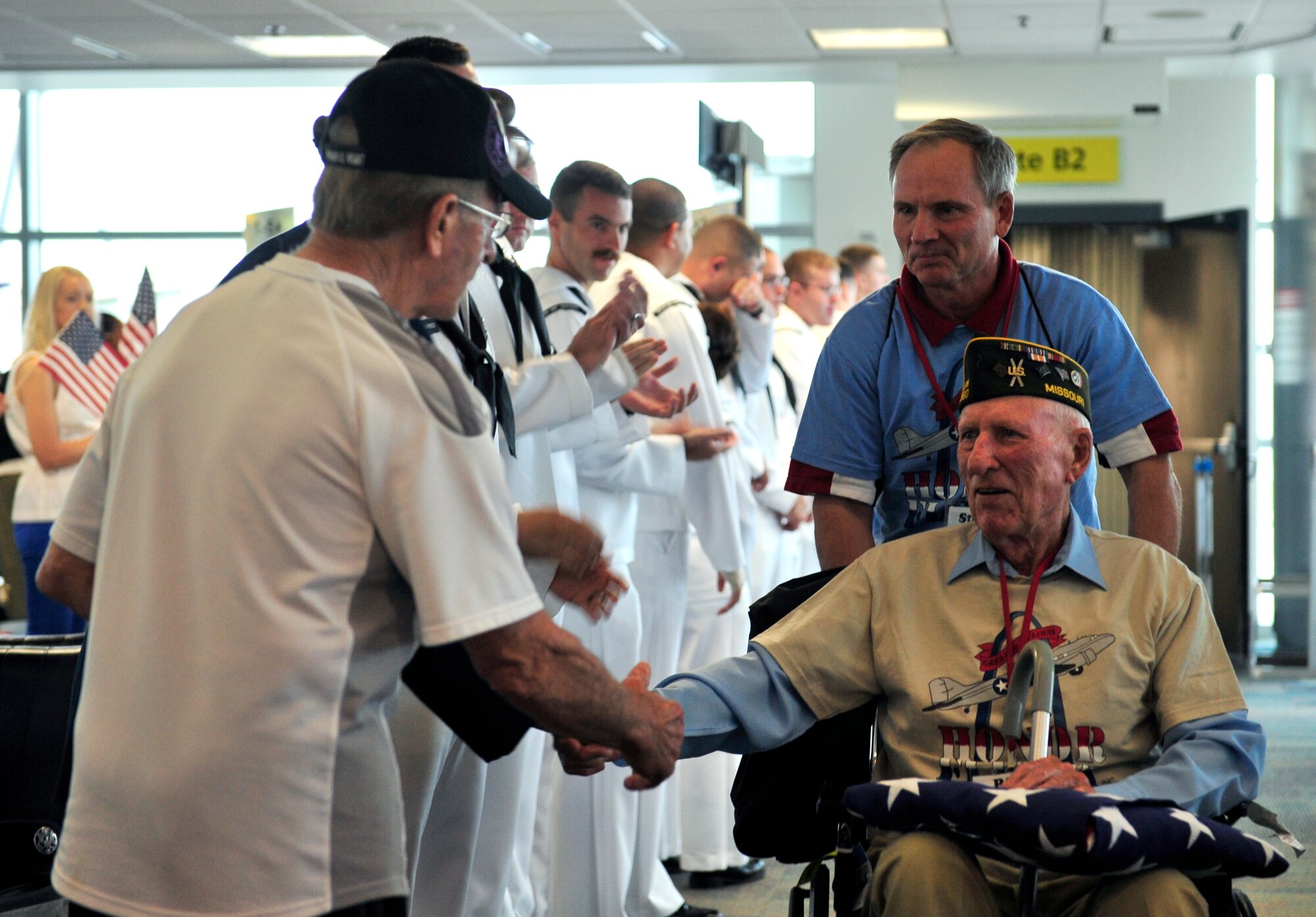 Dave Hinrichs, an 83-year-old Army veteran is greeted by members of the Navy May 21, as he departed an aircraft for a tour of Washington D.C. memorials. Military members greeted the veterans upon their arrival in D.C and in St. Louis when arriving home.  (U.S. Air Force photograph/ Staff Sgt. Stephenie Wade