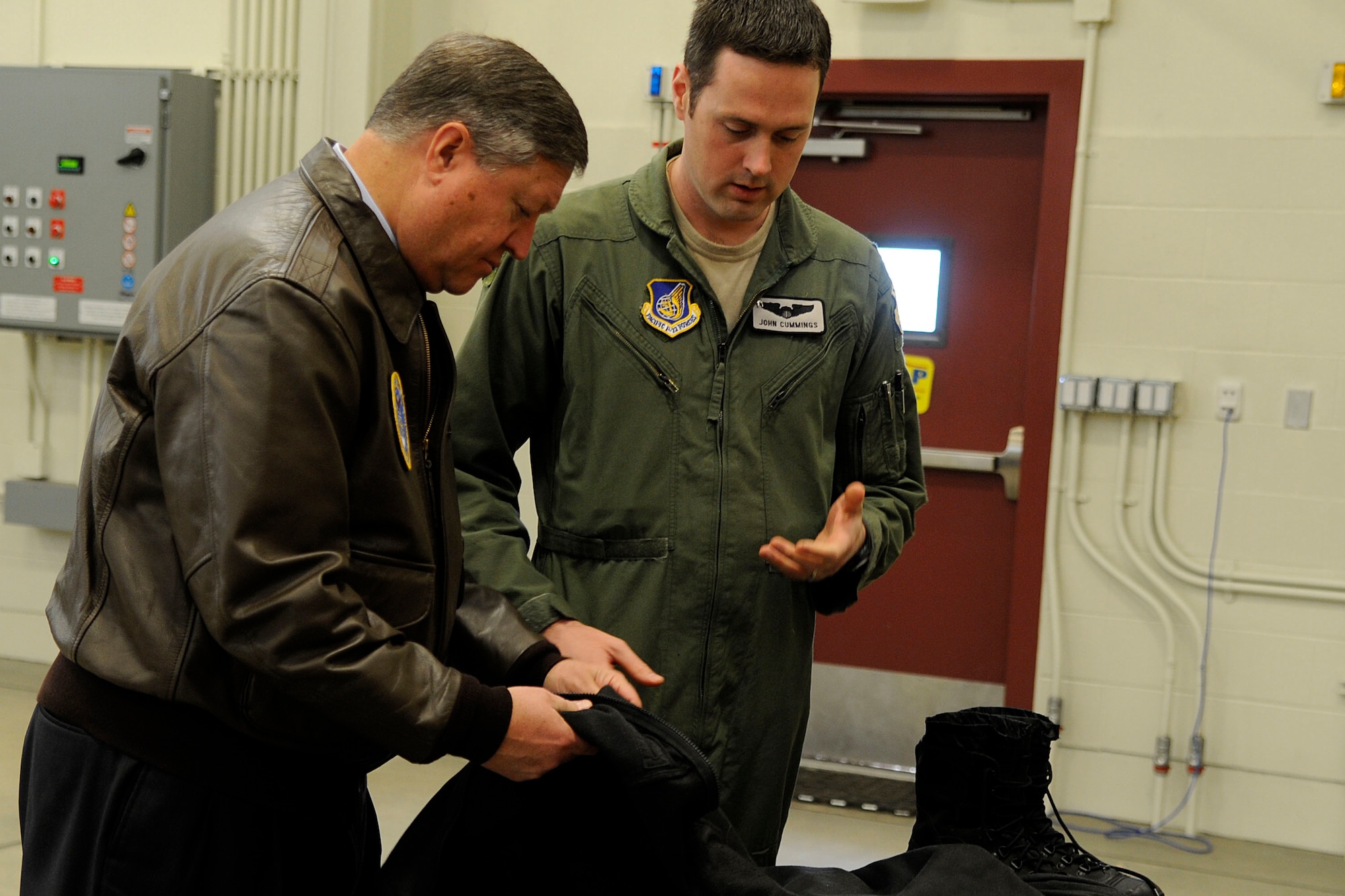 Air Force Capt. John Cummings, F-22A Raptor pilot, shows Secretary of the Air Force Michael Donley winter gear the pilots wear to stay warm during flight operations during the secretary?s visit to Joint Base Elmendorf-Richardson on May 21, 2012. Donley visited JBER to speak to Airmen about the direction of the Air Force, visit them on the job and find out their concerns.  (U.S. Air Force photo/Staff Sgt. Zachary Wolf)

