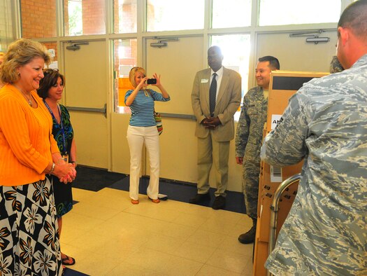 Jan Hollis (left), Waller Elementary School principal, accepts 11 computers from 2nd Communications Squadron representatives at Waller in Bossier City, La., May 22. The computers were allocated to the school through the Department of Defense's Computers for Learning program, which allows military surplus computers to be donated to schools and nonprofit educational organizations. The program saves both the DOD and schools money as the schools do not have to purchase new equipment and the military does not have to pay to ship, disassemble and recycle the computers. (U.S. Air Force Photo/Tech. Sgt. Mike Andriacco)