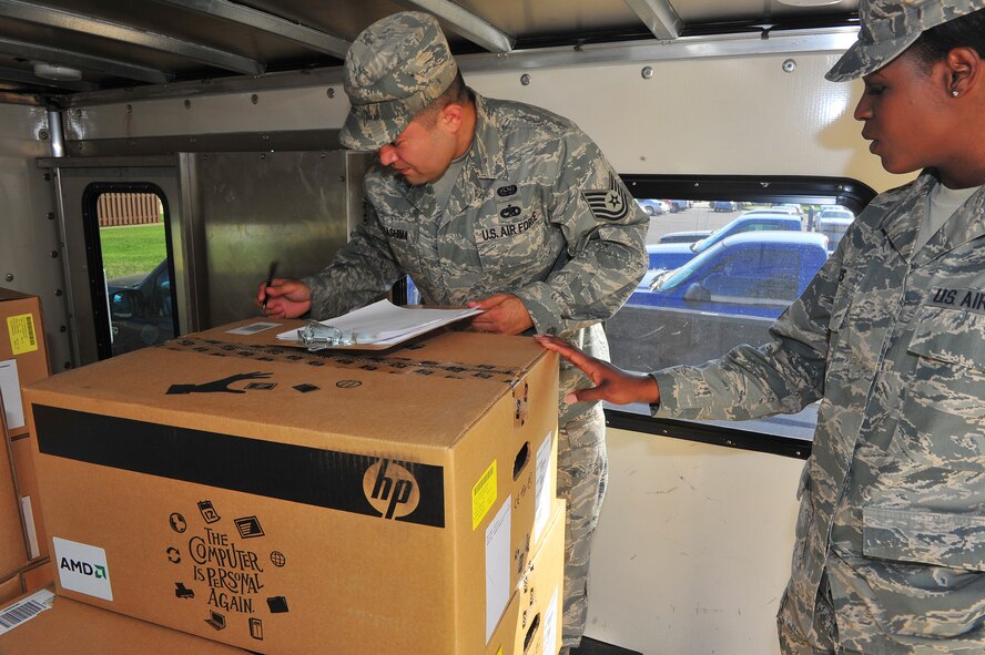 Tech. Sgt. Marcus Nakashima and Staff Sgt. Jennifer Giles, 2nd Communications Squadron, ensure accountability of computers to be donated to Bossier City schools under the Department of Defense's Computers for Learning program on Barksdale Air Force Base, La., May 22. The program allows government agencies to donate educationally useful equipment to schools if it still has useful life left and the schools qualify to participate in the program. (U.S. Air Force Photo/Tech. Sgt. Mike Andriacco)