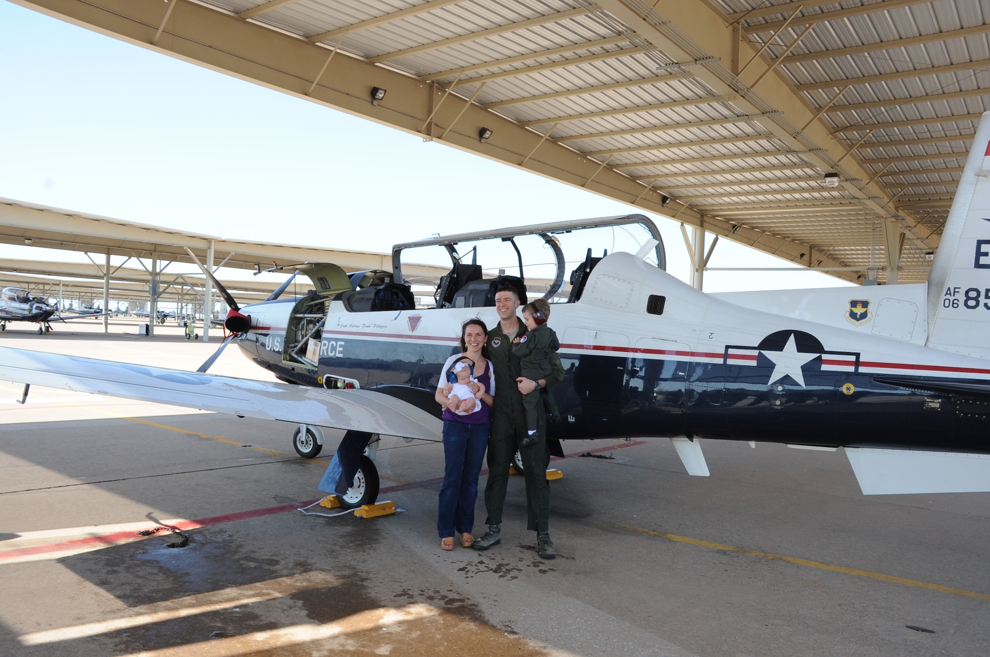 Capt. Andrew Pellegrin and his wife Jennifer pose next to the T-6 along with his two children Jude and Claire at Sheppard Air Force Base. Pellegrin celebrated his final flight with his family and other instructor pilots. (U.S. Air Force photo/2nd Lt. Jerred Moon)