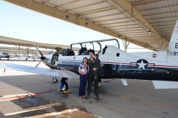 Capt. Andrew Pellegrin and his wife Jennifer pose next to the T-6 along with his two children Jude and Claire at Sheppard Air Force Base. Pellegrin celebrated his final flight with his family and other instructor pilots. (U.S. Air Force photo/2nd Lt. Jerred Moon)