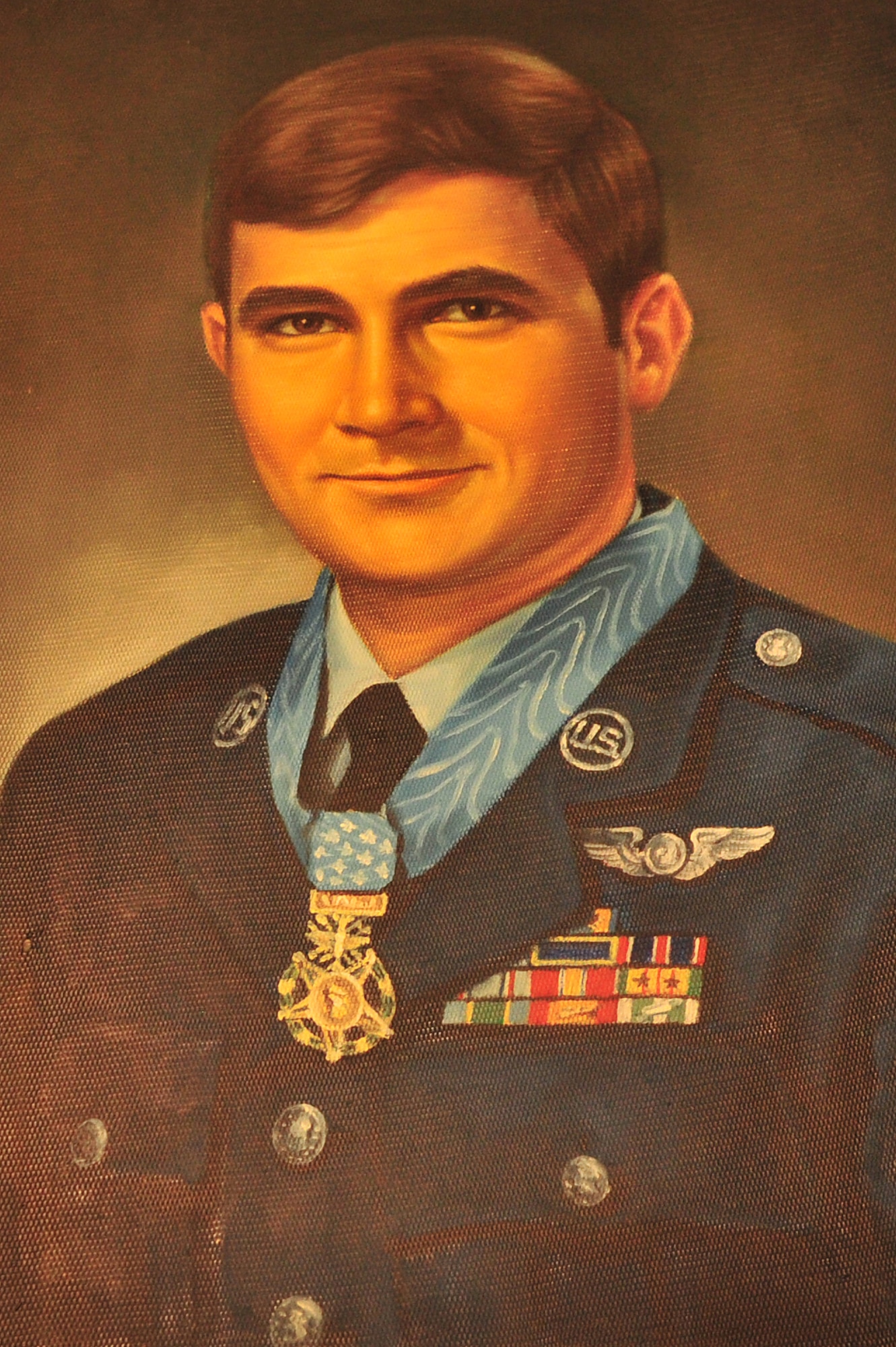 A portrait of John Lee Levitow hangs near a newly unveiled memorial in the heritage room of the 3rd Special Operations Squadron at Cannon Air Force Base, N.M., May 22, 2012. Levitow was an AC-47 gunship loadmaster who became the lowest ranking Airman to ever receive the Medal of Honor for exceptional heroism during a time of war. (U.S. Air Force photo by Airman 1st Class Xavier Lockley)   
