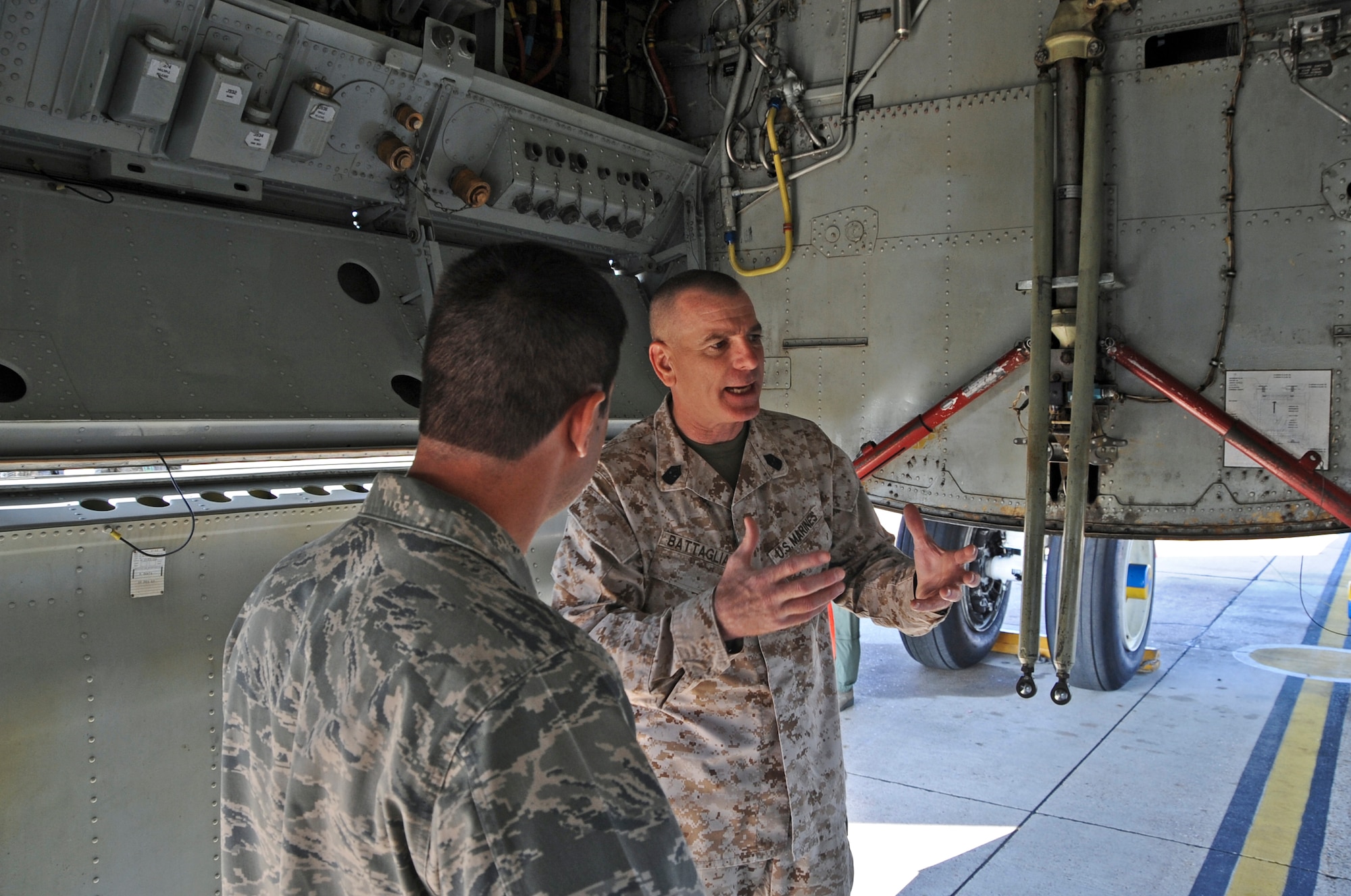 U.S. Marine Corps Sgt. Maj. Bryan Battaglia, senior enlisted advisor to the chairman of the Joint Chiefs of Staff, talks with Col. Andrew Gebara, 2nd Bomb Wing commander, about how aircrew members are able to move throughout the B-52H Stratofortress on Barksdale Air Force Base, La., May 22. Aircrew members can move from the flight deck to the tail of a B-52 while in flight via a small pathway located in the bomb bay. Battaglia visited Barksdale to interact with Airmen and find out what issues are important to them on and off duty. (U.S. Air Force photo/Airman 1st Class Micaiah Anthony)(RELEASED)