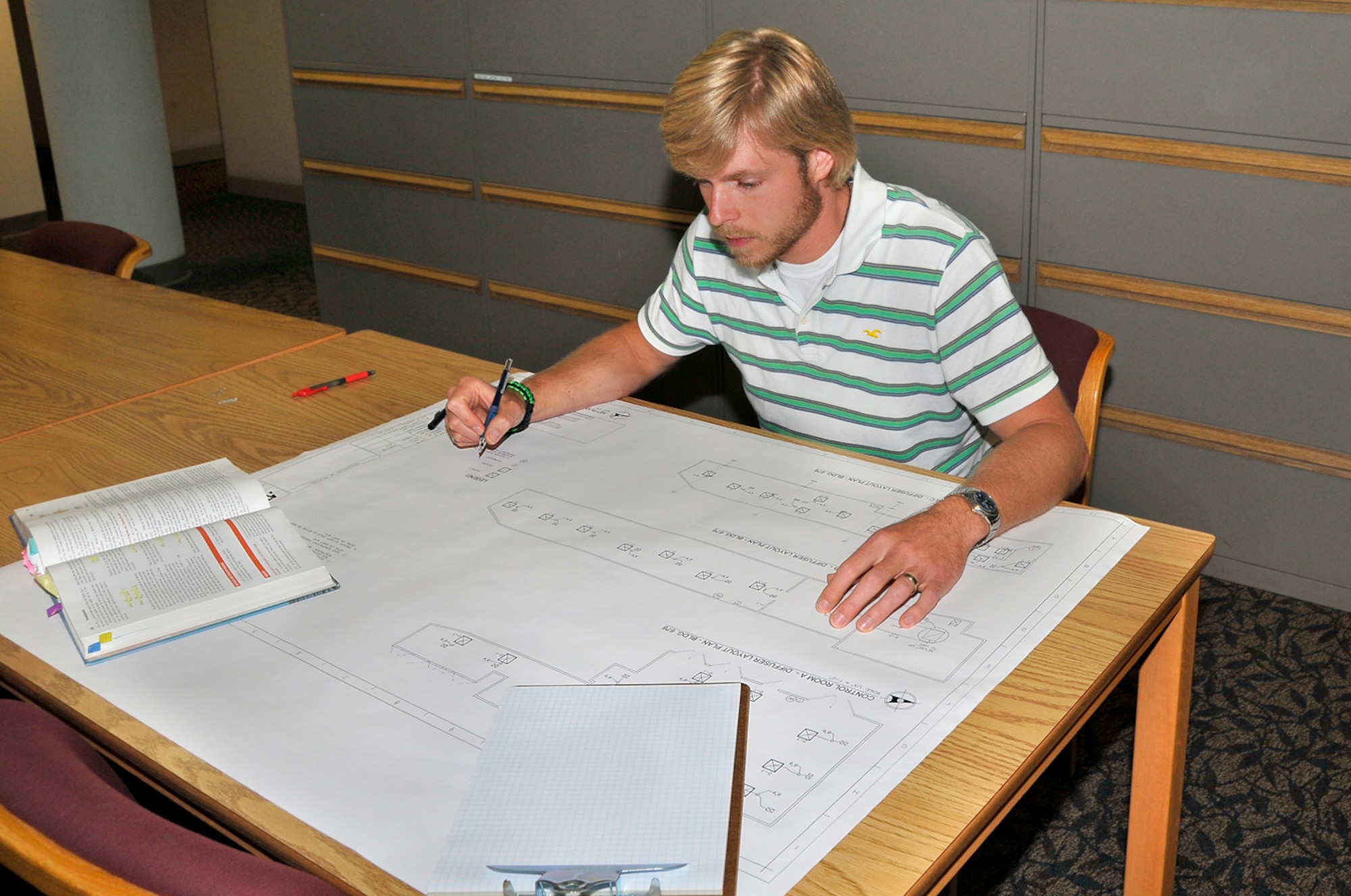 Aaron Wiser, an ATA Design Engineering Branch draftsman, employs the newest CADD technology for his work (below), but still gets the big picture with actual drawings and blueprints of a project. Wiser just graduated from the University of Tennessee at Chattanooga with a bachelor’s of science degree in mechanical engineering. (Photos by Jacqueline Cowan)