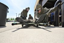 MINOT AIR FORCE BASE, N.D. -- Airmen from the 5th Medical Group, strap a patient on a stretcher during a major accident response exercise here, May 17. With 55 mock casualties as part of the scenario, the entire medical group had their work cut out for them as the first line responders for medical support. (U.S. Air Force photo/Senior Airman Brittany Y. Auld)