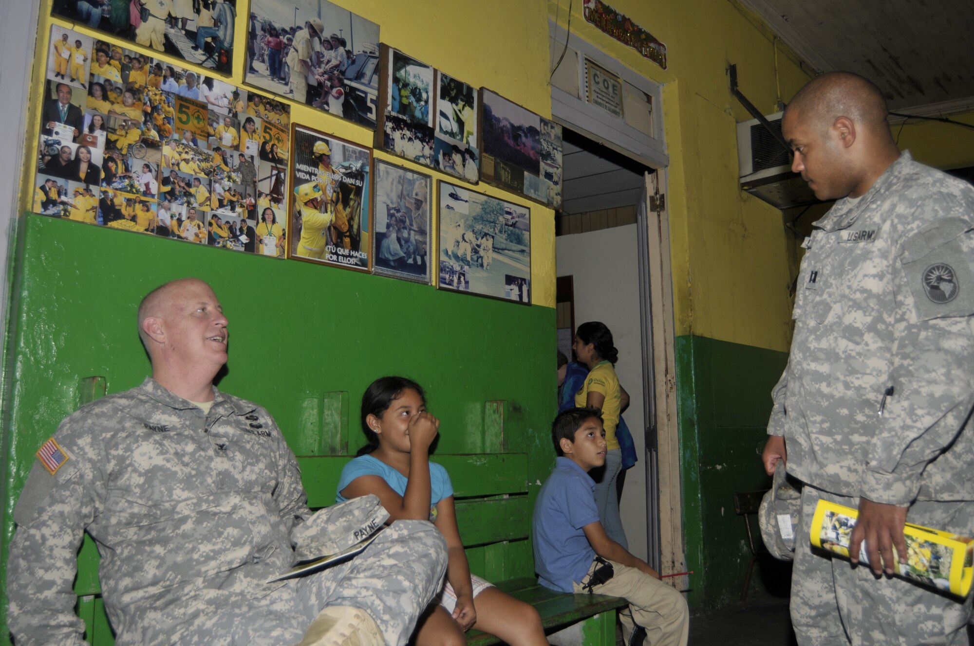 Col. Dort Payne, Army South, Deputy Surgeon (left) and Capt. Jose Mendez, N.H. National Guard, Bilateral Affairs Officer, chat with El Salvadoran kids during a tour of the Comandos de Salvamento Green Cross facility San Salvador, El Salvador, May 10, 2012, as part of the ongoing National Guard State Partnership Program. (Released/National Guard photo by Tech. Sgt. Aaron Vezeau)