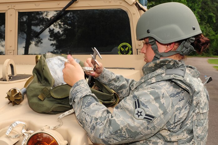 Airman 1st Class Amber Taft, Explosive Ordnance Disposal journeyman from the 628th Civil Engineer Squadron, out of Joint Base Charleston, S.C., measures an object May 21, 2012. This scenario, which involves identifying different UXO's, is a part of Taft's 5-level upgrade training.  (U.S. Air Force photo/ Airman 1st Class Chacarra Walker)