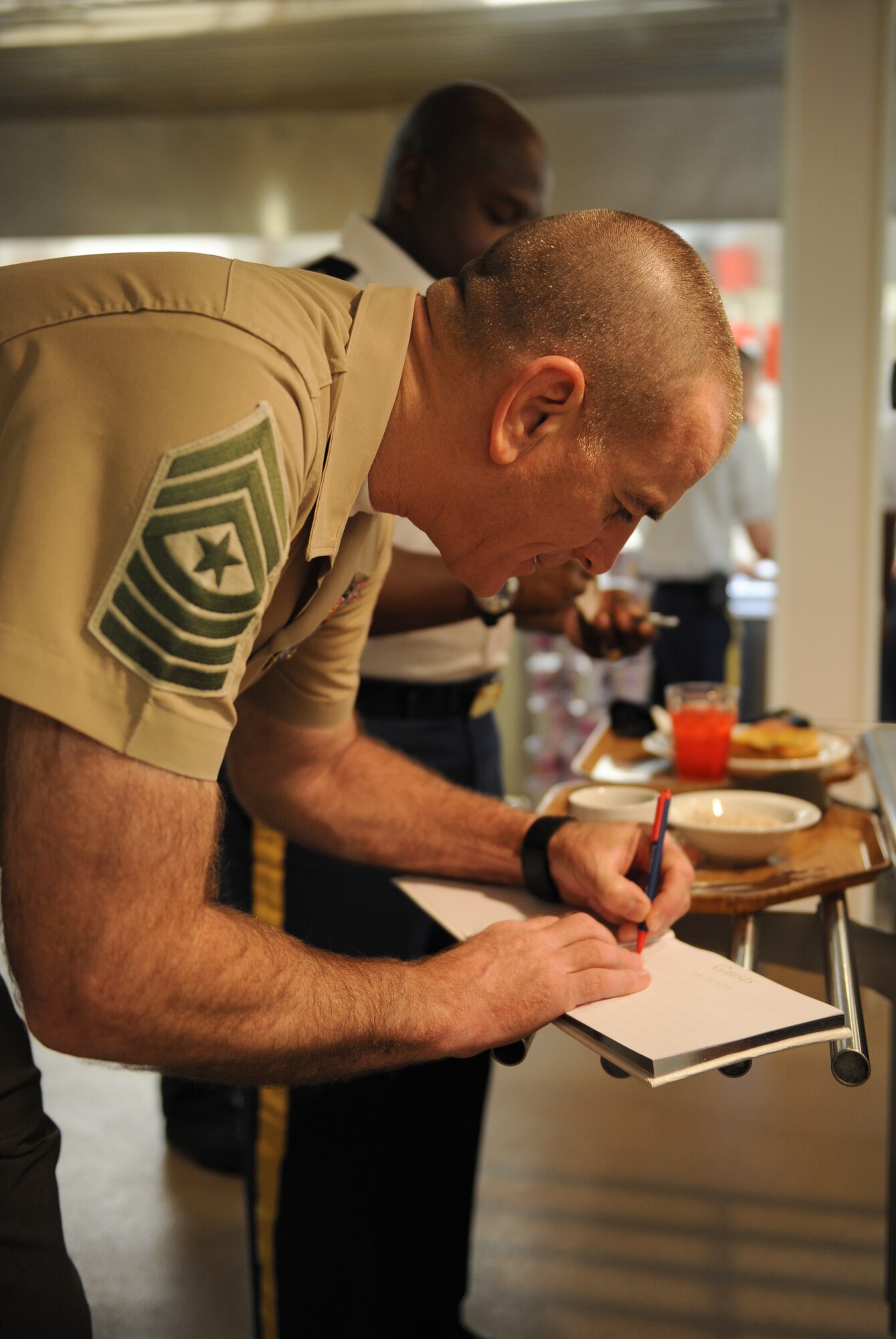 U.S. Marine Corps Sgt. Maj. Bryan Battaglia, senior enlisted advisor to the chairman of the Joint Chiefs of Staff, signs a guestbook at the Red River Dining facility on Barksdale Air Force Base, La., May 21. Battaglia and U.S. Army Command Sgt. Maj. Patrick Alston, senior enlisted leader to the U.S. Strategic Command, visited with Barksdale Airmen to discuss leadership, civilian education, suicide prevention and other topics relevant to all service members. (U.S. Air Force photo/Airman 1st Class Benjamin Gonsier)(RELEASED)