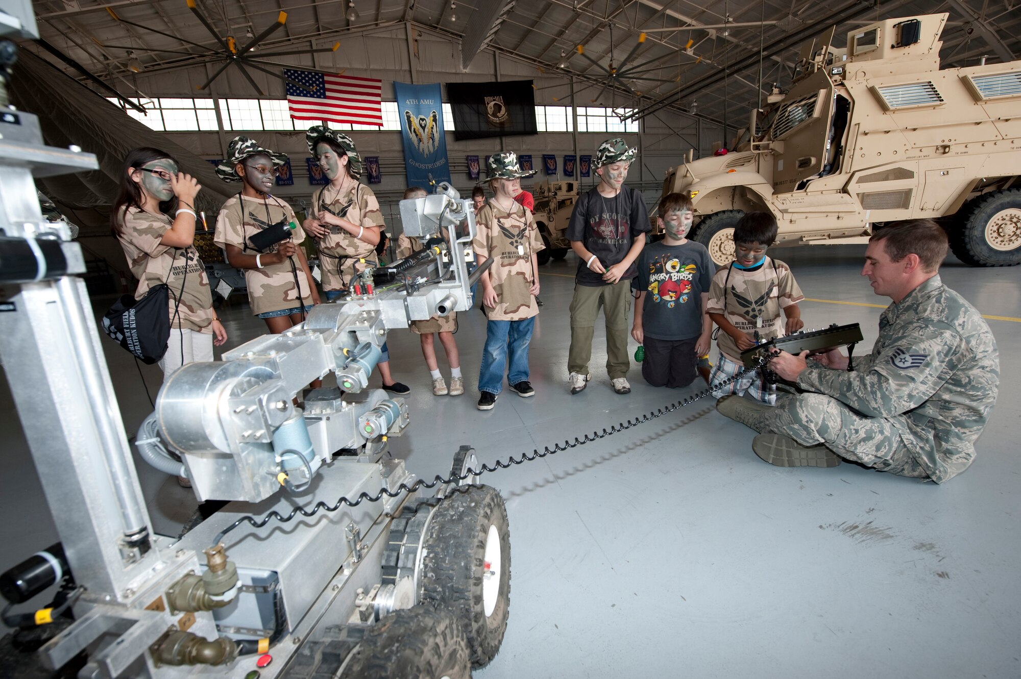 Staff Sgt. Richard Peterson, an explosive ordnance disposal technician of 1st Special Operations Civil Engineer Squadron, shows the functions of a remotely controlled EOD robot during the Kids Understanding Deployment Operations event at the Commando Hangar at Hurlburt Field, Fla., May 19, 2012. The children attending the KUDOS event can get an up close and personal view of a variety of static ground vehicles and aircraft from the 1st Special Operations Wing. (U.S. Air Force photo/Airman 1st Class Benjamin Kim)(RELEASED)