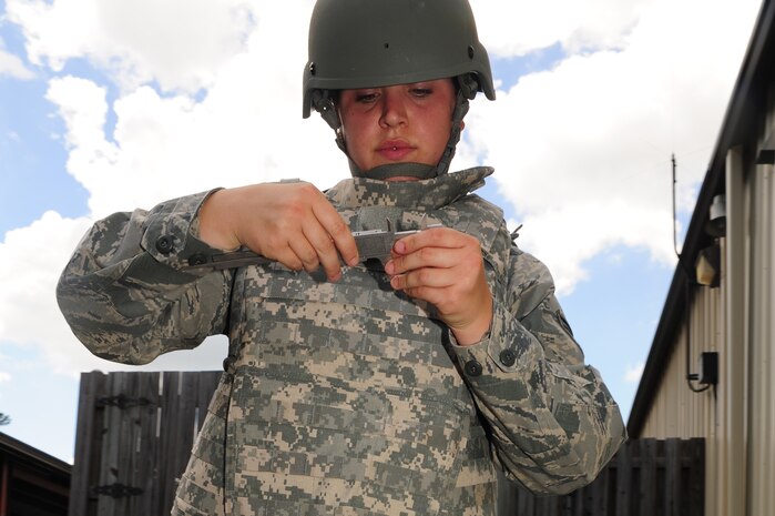 Airman 1st Class Amber Taft, Explosive Ordnance Disposal journeyman from the 628th Civil Engineer Squadron, out of Joint Base Charleston, S.C., looks at an unidentified explosive object, May 21, 2012. This scenario, which involves identifying different UXO's, is a part of Hardy's 5-level upgrade training. (U.S. Air Force photo/ Airman 1st Class Chacarra Walker)