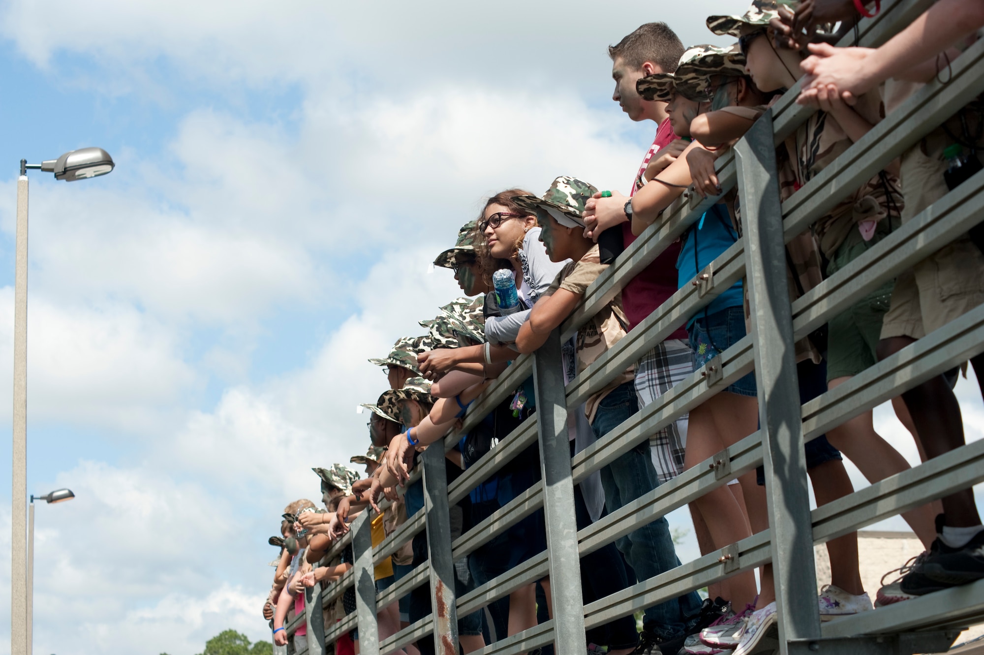 Children stand at the top of bleachers to observe a K-9 demonstration held by the 1st Special Operations Security Forces Squadron outside the base Deployment Control Center at Hurlburt Field, Fla., May 19, 2012.  The K-9 demonstration is one of many informative parts of the KUDOS event to show various aspects of deployment. (U.S. Air Force photo/Airman 1st Class Benjamin Kim)(RELEASED)