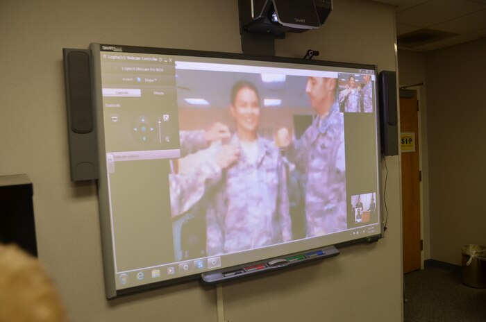 A live video feed shows Maj. Monica Lovasz being pinned to the rank of lieutenant colonel by the 387th AEG commander and the 325th Combat Support Hospital commander at Camp Buehring, Kuwait, May 21. Lovasz wanted to share her promotion ceremony with her family, friends and co-workers from Joint Base Charleston. (U.S. Air Force photo/Senior Airman Anthony J. Hyatt)