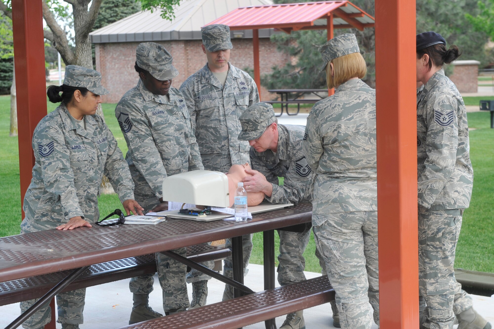 Airmen practice Self Aid Buddy Care May 10, 2012, at Eagle Park. The training was part of ongoing 21st Space Wing Ability to Survive and Operate instruction for cadre members across the base. Cadre members will be core personnel providing leadership and training in the event of a mass deployment of 21st Space Wing personnel. (U. S Air Force photo/Robb Lingley)