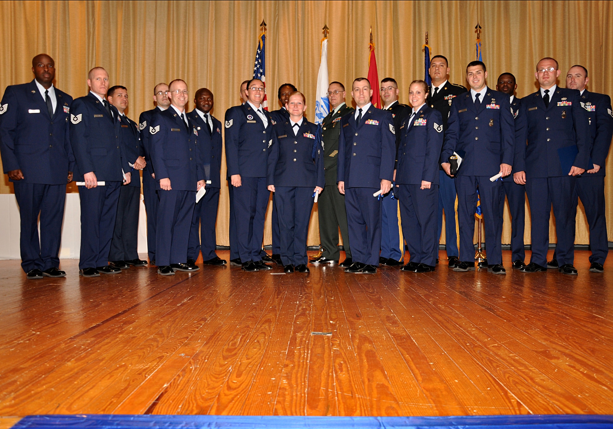 GOODFELLOW AIR FORCE BASE, Texas -- Community College of the Air Force graduates accepts their degrees in various fields during the graduation ceremony May 18 at the base theater. The CCAF offers job-related associate degrees in applied science and other academic credentials that enhance mission readiness. (U.S. Air Force photo/ Staff Sgt. Tong Duong)