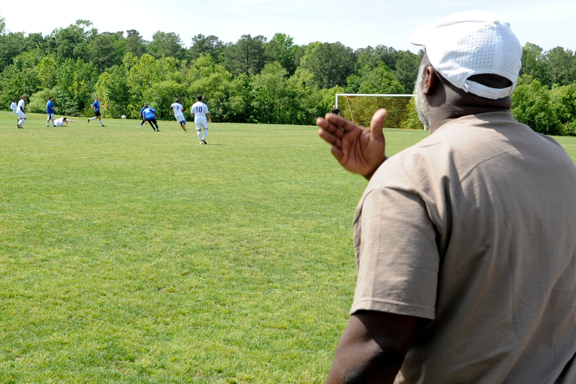 Mr. JR Richardson, Langley Air Force Base Soccer Team coach, yells instructions from the sidelines during a soccer game in Yorktown, Va., May 12, 2012. Richardson is one of two team coaches that motivate and push the team to succeed. (U.S. Air Force photo by Senior Airman Wesley Farnsworth/Released)