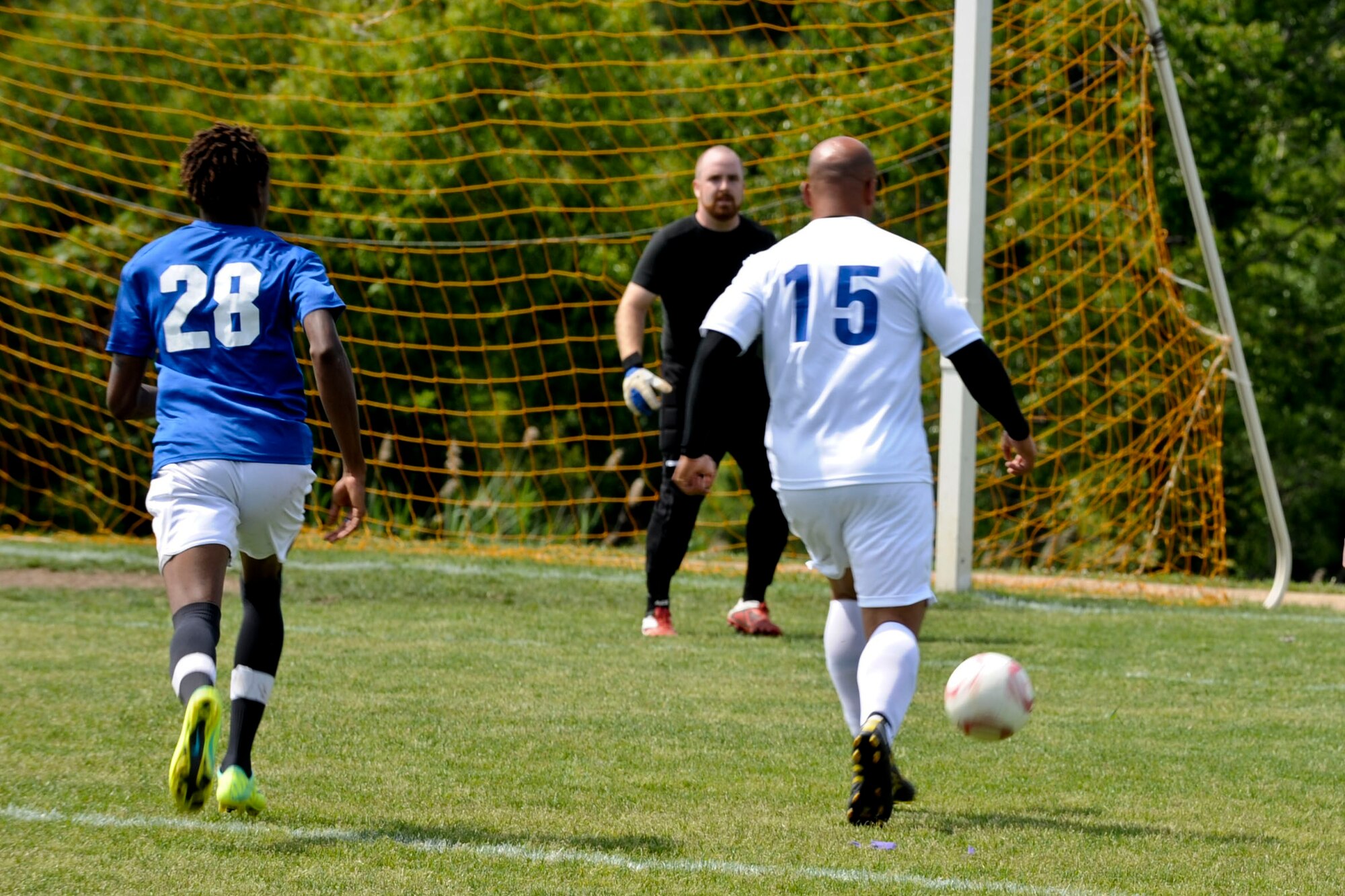 U.S. Air Force Staff Sgt. James Healey, Langley Air Force Base Soccer Team striker, runs the ball downfield during a soccer game in Yorktown, Va., May 12, 2012. The team went on to win the game, crushing their oppenents 22-0.  (U.S. Air Force photo by Senior Airman Wesley Farnsworth/Released)