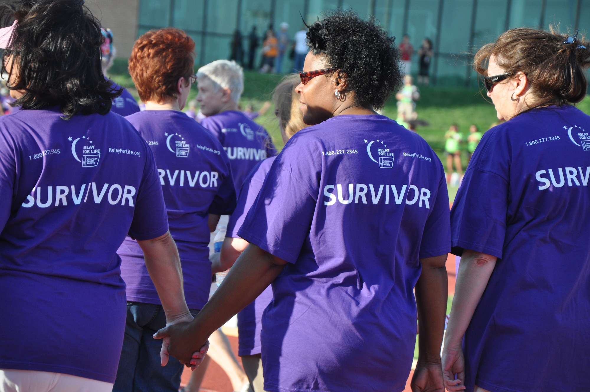 SAN ANGELO, Texas - Survivors circle the LeGrand Sports Complex track, Angelo State University, during the 2012 Relay For Life, May 18. The relay starts with a Survivors Lap, an inspirational time when survivors are invited to circle the track together and help everyone celebrate the victories they've achieved over cancer. (U.S. Air Force photo/Senior Airman Anne Gathua)  