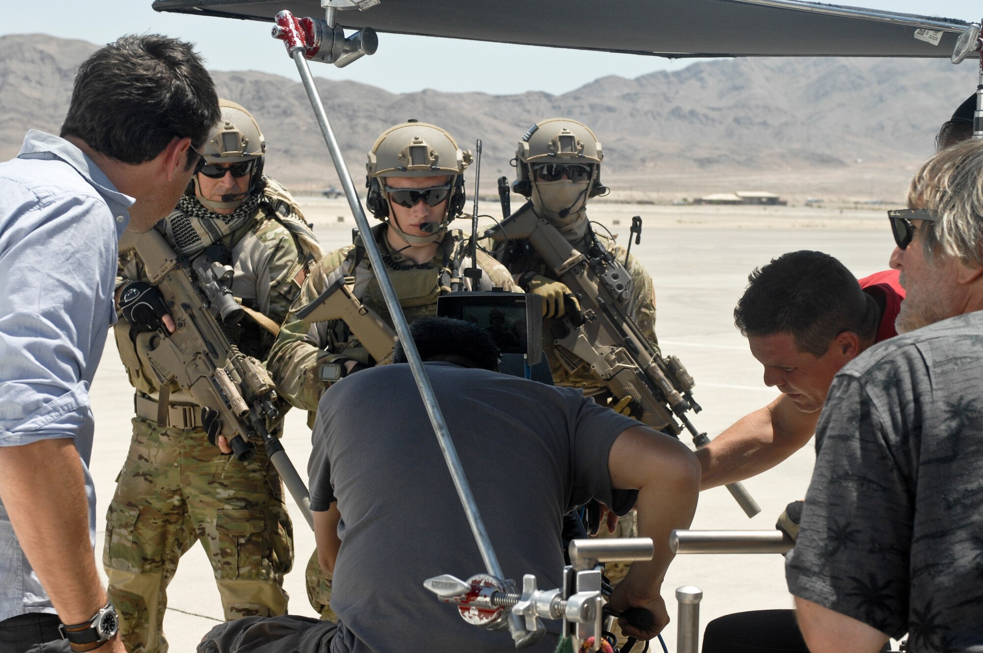 Combat Control Technicians from McCord Air Force base and crew members from GSD&M, advertising agency film "Hero shots" May 15, 2012, at Nellis Air Force Base, Nev for "Rapid Strike" recruiting truck tour. Nellis Air Force Base, the Air Force Recruiting Service and Randolf Air Force Base, coordinated to help produce the newest Air Force recruiting tool “Rapid Strike.” (U.S. Photo by Senior Airman Jack Sanders)
