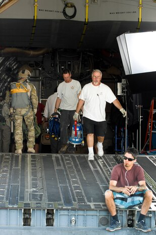 Crew members from Gurasich Spence Darilek and McClure advertising agency work on the back of a C-17 during a filming May 15, 2012, at Nellis Air Force Base, Nev for "Rapid Strike"a recruiting truck tour. “Rapid Strike” is a combination of real world footage, computer generated imagery, and engineering combined into a four dimensional experience designed to put the viewer into the action. (U.S. Photo by Senior Airman Jack Sanders)
