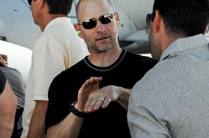 Jeff Johnson, Executive Producer for Gurasich Spence Darilek and McClure, advertising agency discusses a scene with a coworker during filming May 15, 2012, at Nellis Air Force Base, Nev. for the "Rapid Strike" mobile truck tour. The "Rapid Strike" tour combines live action footage, computer generated imagery, and engineering to create a four-dimensional experience designed to put the viewer in the action of an Air Force Mission. (U.S. Photo by Senior Airman Jack Sanders)