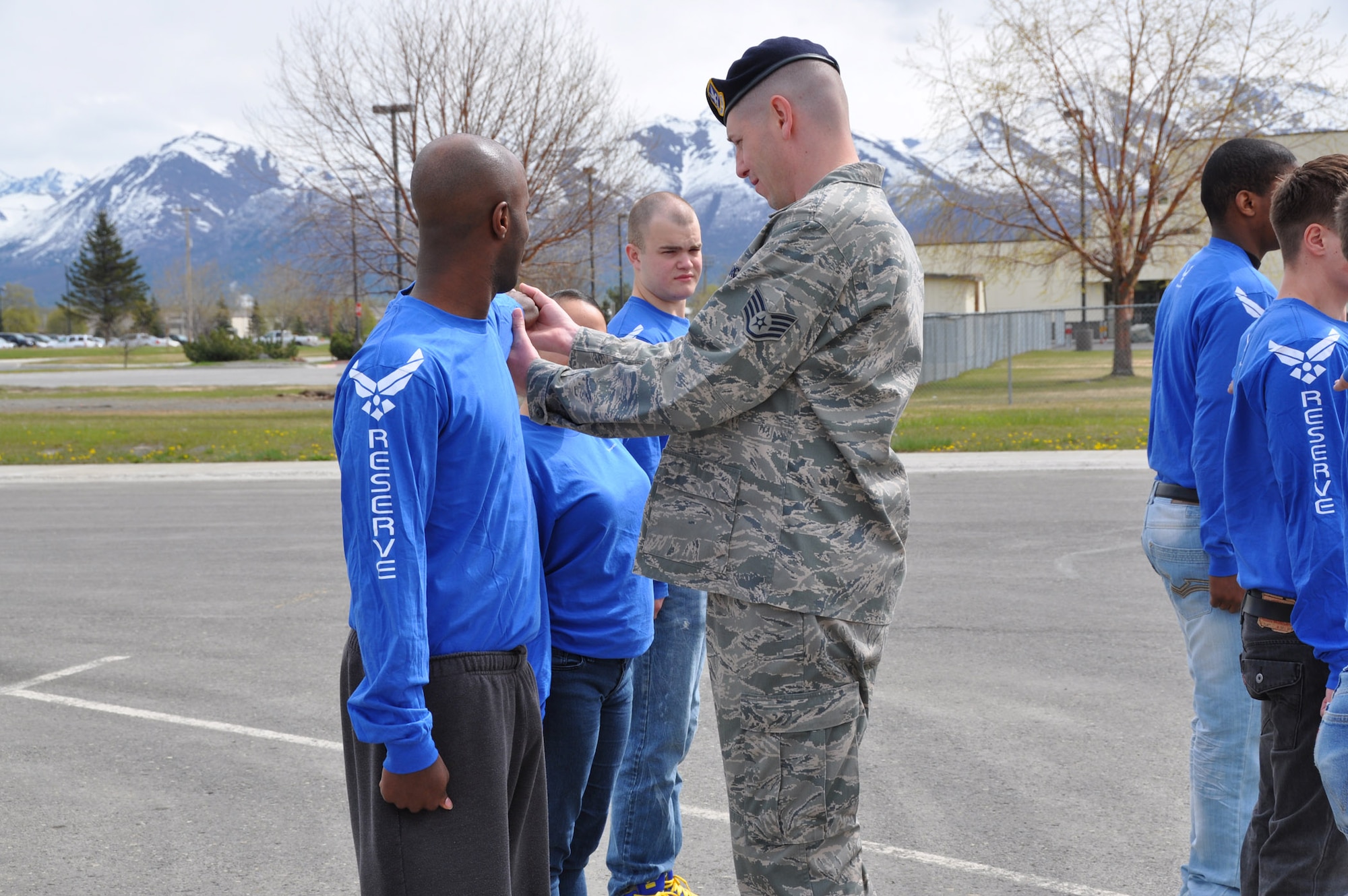 Staff Sgt. Travis Marshall, 477th FG Development and Training Flight Facilitator, shows an enlistee how to properly execute dress right, dress during a lesson on Drill and Ceremonies here May 20. The D&T flight stood up to teach Airmen the basics of Air Force customs and courtesies, Drill and Ceremony, and physical fitness prior to arrival at Basic Military Training. (U.S. Air Force photo/Capt. Ashley Conner)