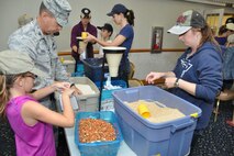 Col. James Hurley volunteered with nearly 50 other people on-base recently to help support the Stop Hunger Now initiative. More than 11,000 packages of food were prepared during the event that was organized by 916th Inspector General Janette Thode. (USAF photo by Maj. Nicole Hurley, 916ARW, released)