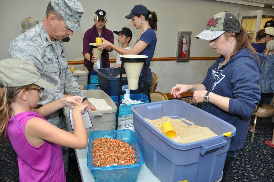 Col. James Hurley volunteered with nearly 50 other people on-base recently to help support the Stop Hunger Now initiative. More than 11,000 packages of food were prepared during the event that was organized by 916th Inspector General Janette Thode. (USAF photo by Maj. Nicole Hurley, 916ARW, released)